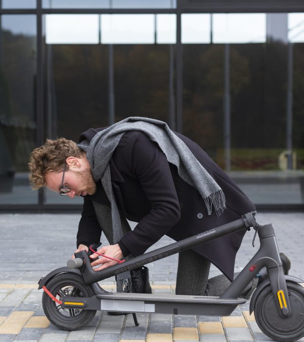 adult-male-repairing-his-electric-scooter